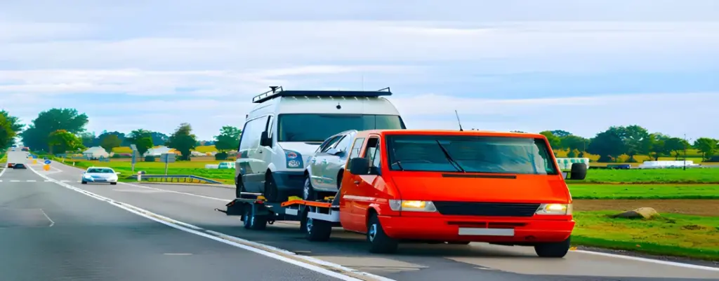 a van towing a car on a trailer